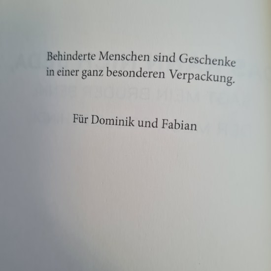 Schwarze Schrift auf weißem Grund: Behinderte Menschen sind Geschenke in einer ganz besonderen Verpackung. Für Dominik und Fabian